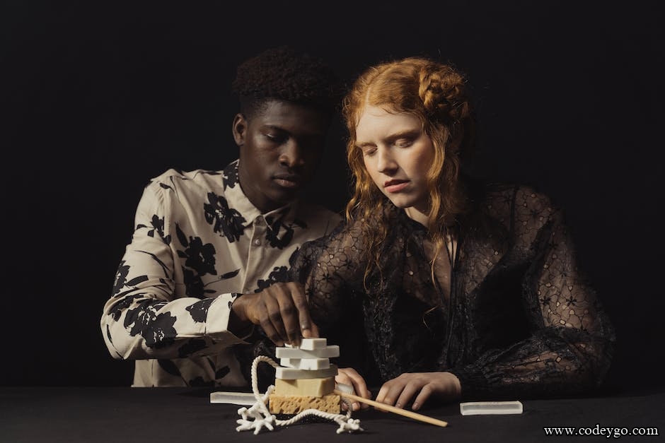 man and red haired woman playing game on table