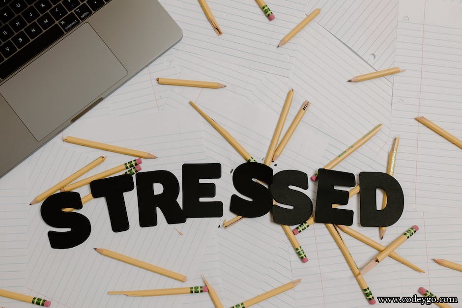 word stressed and pencils near laptop